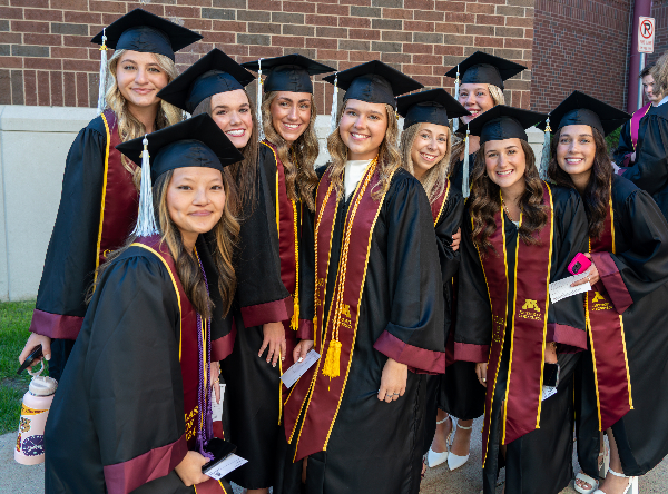 A group of CEHD graduates in cap and gown