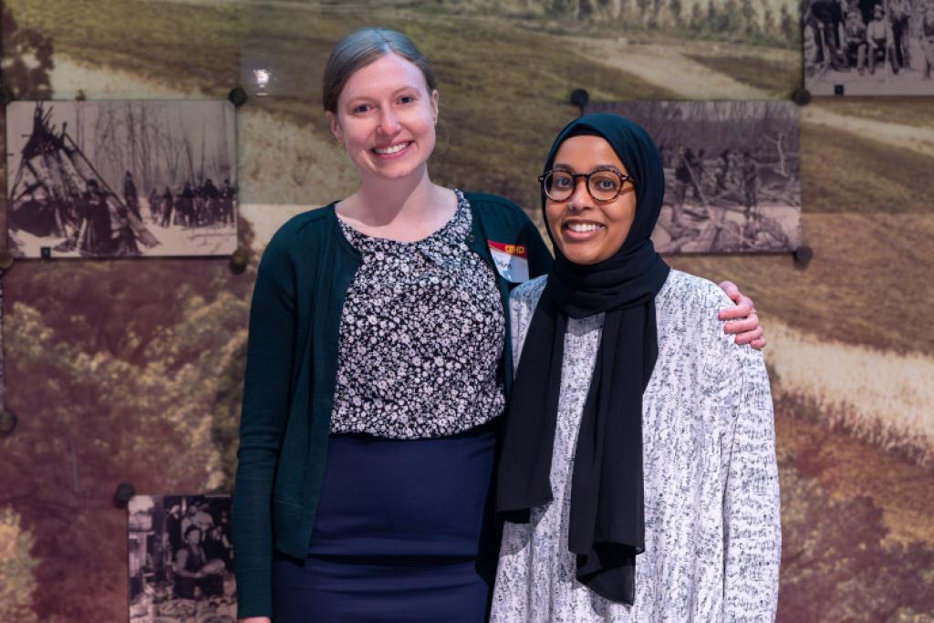 Two attendees smiling together