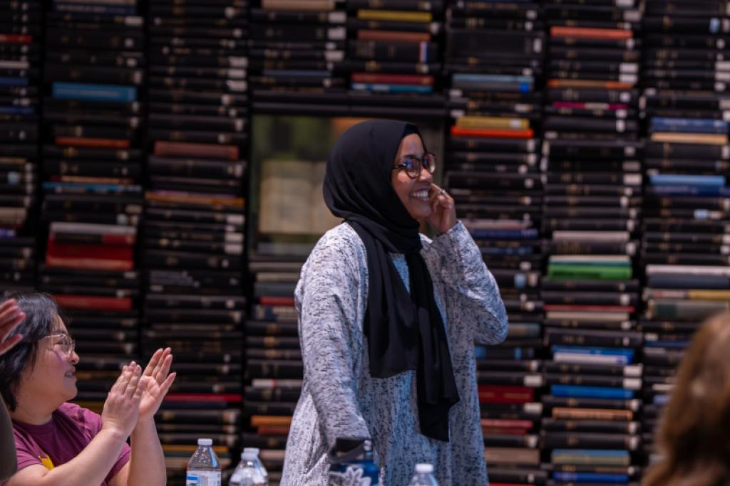 Attendee receiving a round of applause from audience