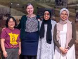 Four attendees smiling together 