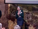 Presenter showing audience research and smiling 