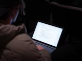 Attendee taking notes on laptop 