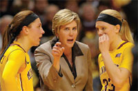 A coach speaking forcefully to her two players