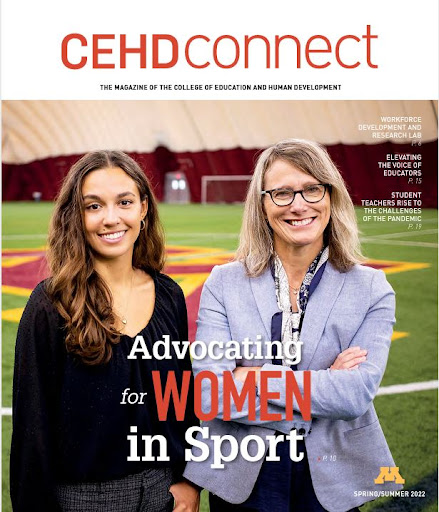 CEHD Connect magazine cover showing student Maxine Simons on left in black top with longer hair and black top and Tucker Center director Nicole M. LaVoi on right in lavendar blazer, arms folded, both in front of a U of M soccer pitch in an inflatable dome stadium